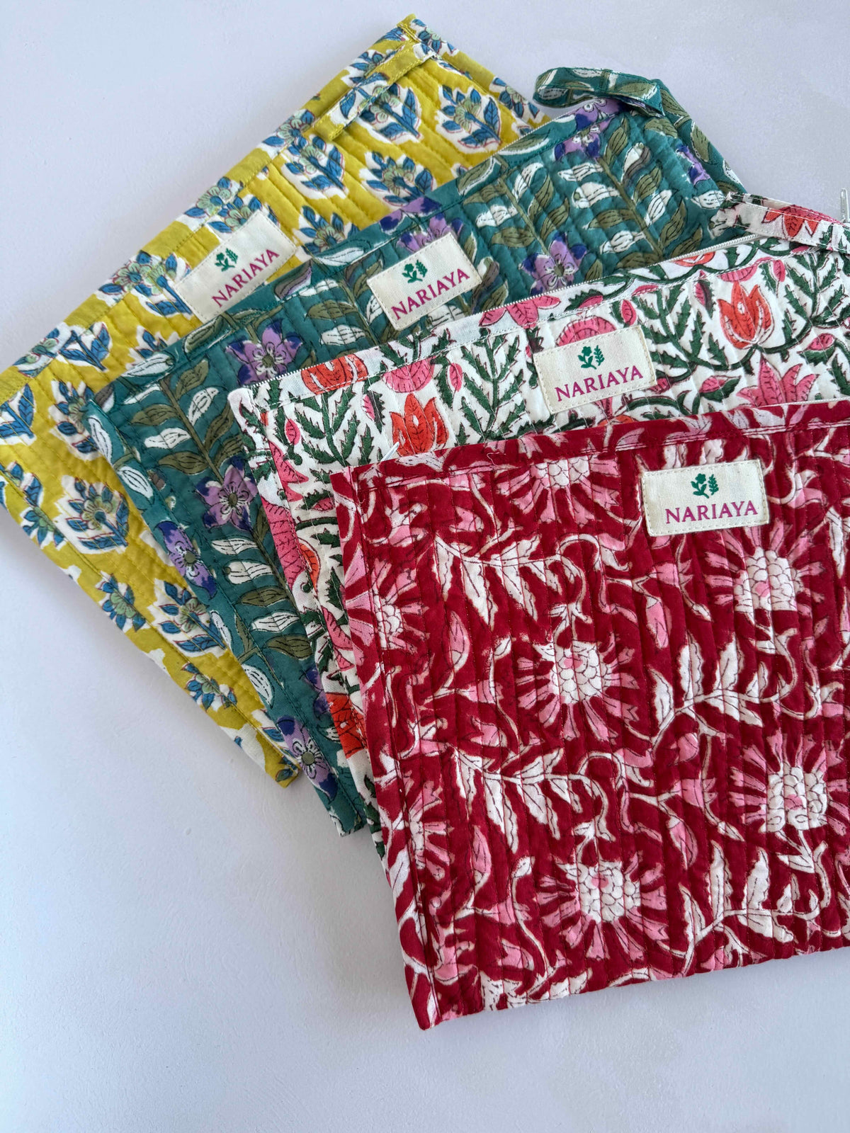 selection of block printed pouches fanned out on a white background 