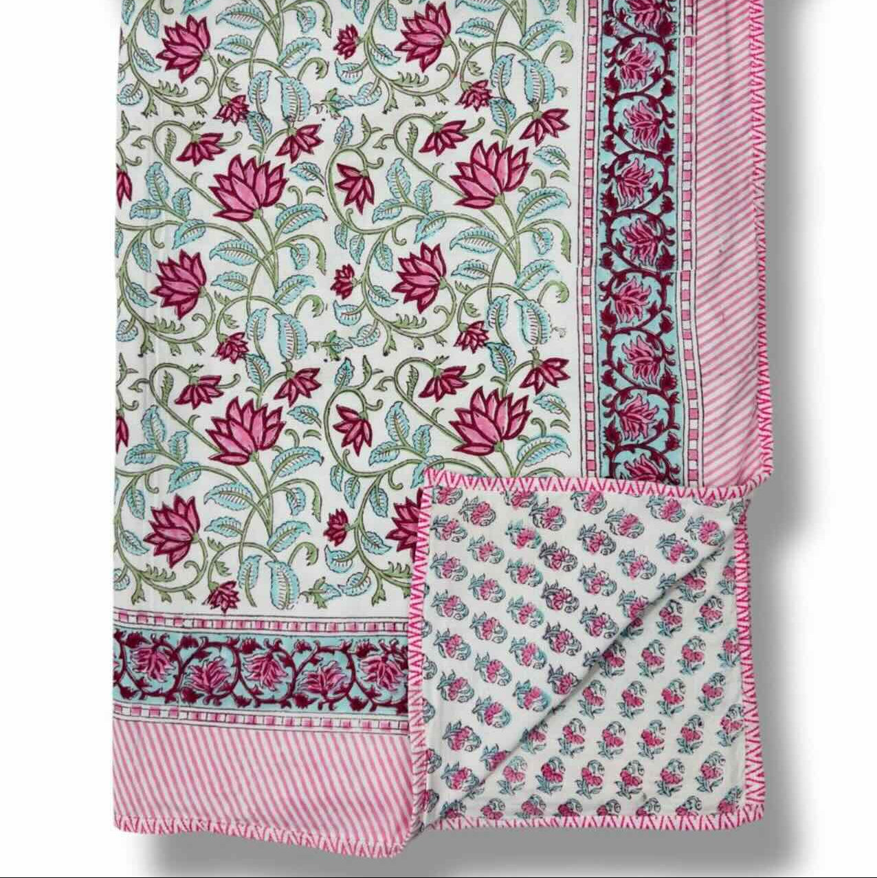 Floral patterned fabric with pink and green design on a white background