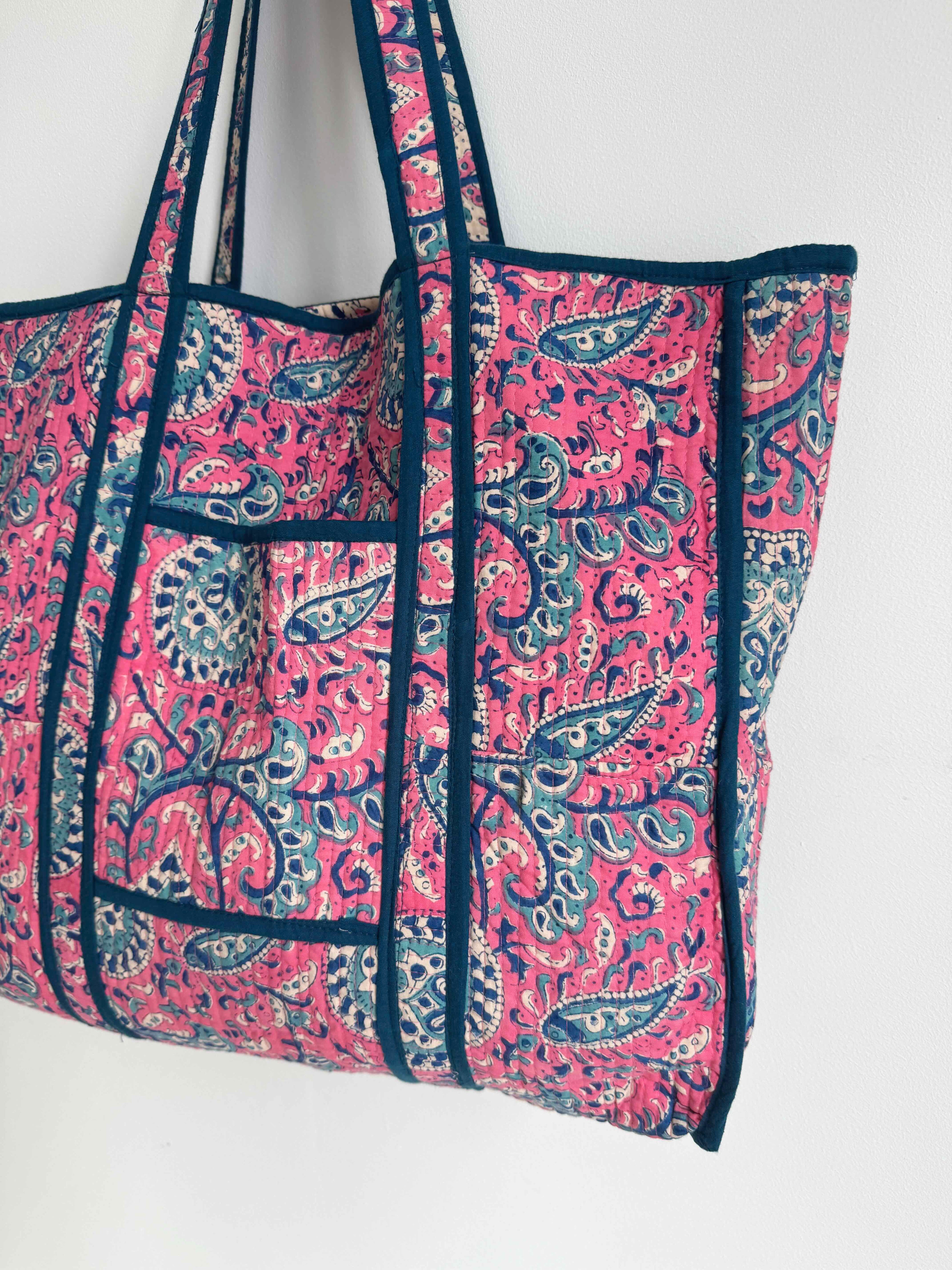 Pink and blue patterned tote bag on a white background